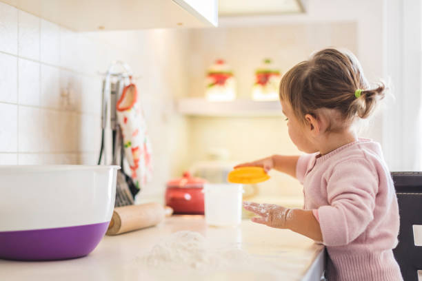 istock Toddler Preparing flour for Kneading the Dough 1283030511