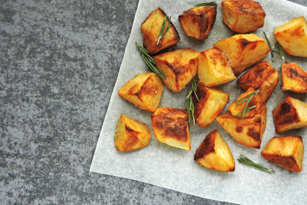 istock Baked potato chunks with rosemary and sauce. 1283030762