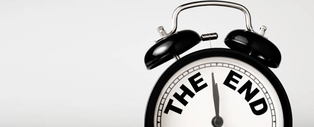 The end wording inside alarm clock with white background and copy space.