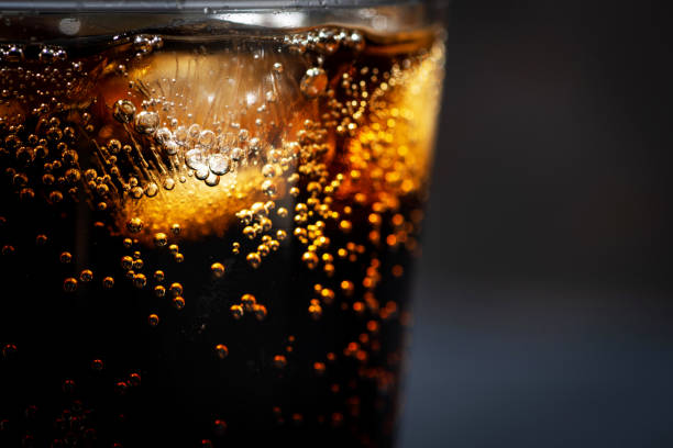 istock glass of coca cola with ice on a black background 1283032041