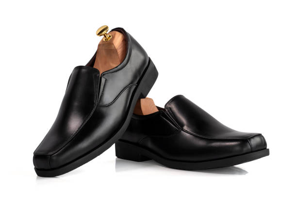 istock Men fashion black shoes  leather with shoe tree (shape supporter) isolate on white background. Clipping path 1283035481
