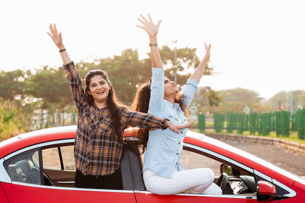 istock Girls having fun on road trip in car 1283036005