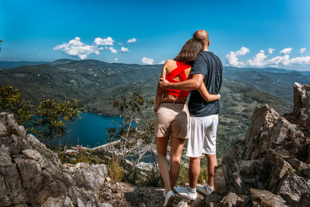 Young couple enjoying a view of Perucac lake and river dam from a magnificent viewpoint in Tara mountain stock photo