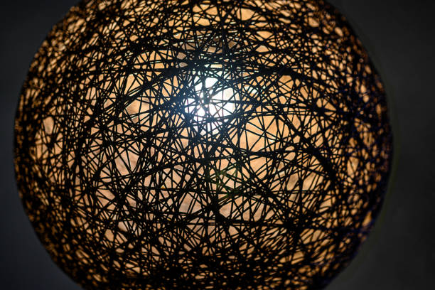 istock Interior lighting is on. Round decorative with wicker texture over lamp, lamp for interior design with dim light 1283040570