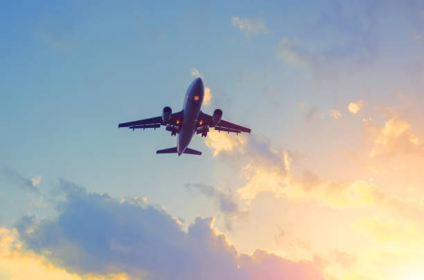 istock Travel by plane in a beautiful sky at sunset with clouds. 1283041440