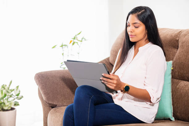 istock Pretty Indian young woman using digital tablet 1283041646