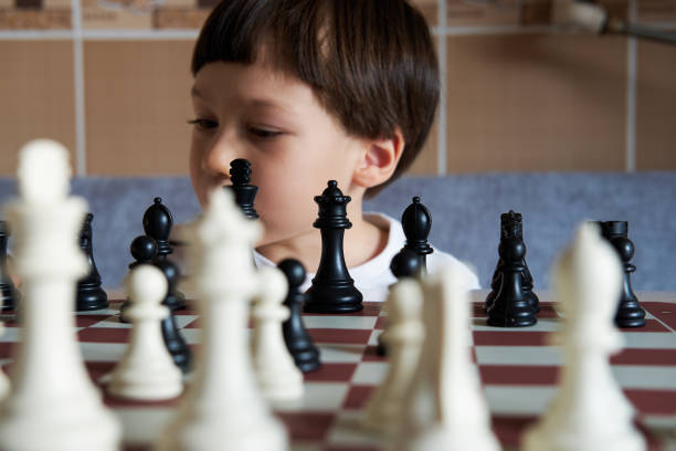 istock 4-5 years old cute child playing chess 1283041775