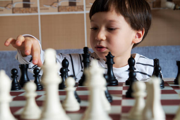 istock 4-5 years old cute child playing chess 1283041811