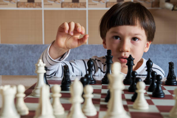 istock 4-5 years old cute child playing chess 1283041822
