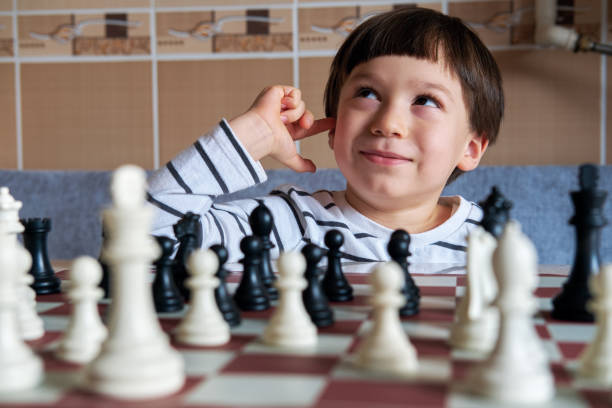istock 4-5 years old cute child playing chess 1283041829
