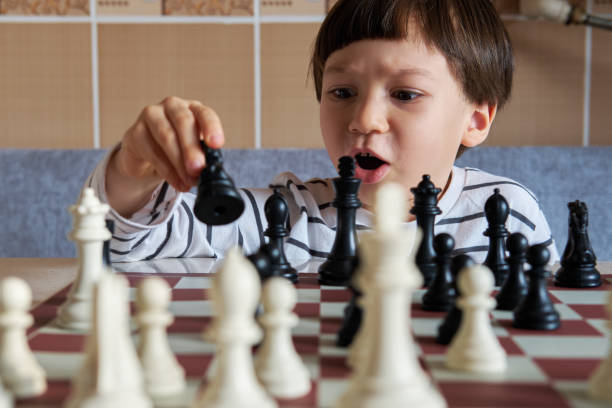 istock 4-5 years old cute child playing chess 1283041840