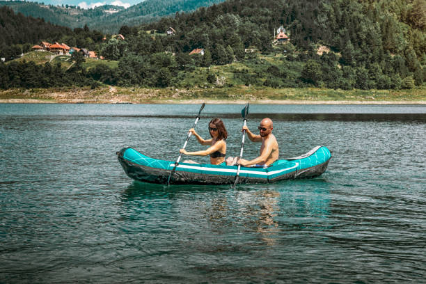 Young couple kayaking in Zaovine lake, Tara mountain stock photo