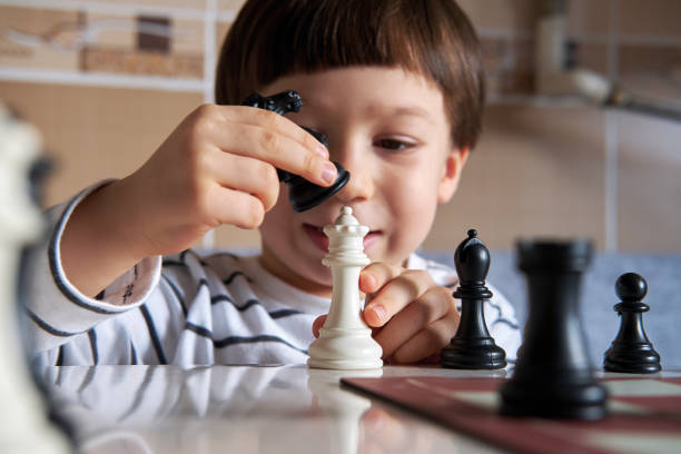 istock 4-5 years old cute child playing chess 1283041932