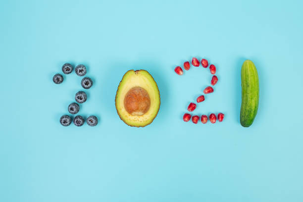 2021 happy new year and new you with fruits; blueberries, avocado, pomegranate seeds and cucumber on blue background. goals, healthy, resolution, time to new start and dieting concept - diabetes superfoods imagens e fotografias de stock