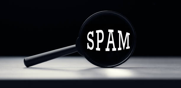 istock Magnifying glass with the word Spam on table 1283044823