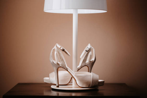 istock Glamorous silver white bridal wedding shoes under a floor lamp 1283045686