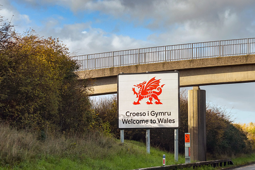 Chepstow, Wales - November 2018: Large sign at the side of the M4 motorway welcoming drivers into  Wales.