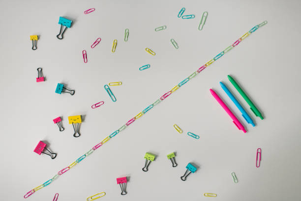 красочные офисные принадлежности разбросаны по столу - ruler ballpoint pen pen isolated стоковые фото и изображения