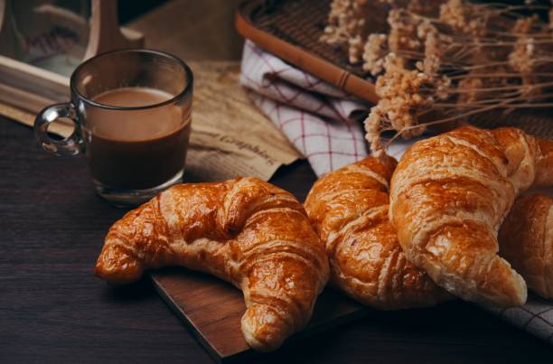 istock Croissants and a cup of coffee on the table 1283048340