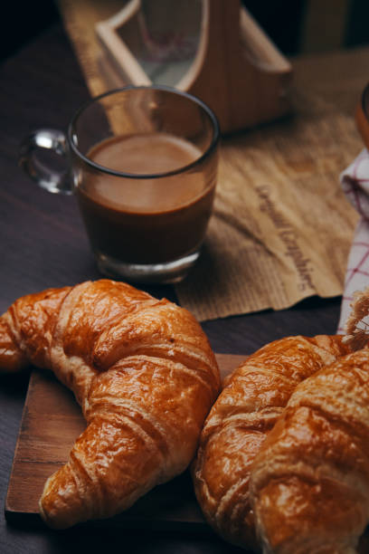 istock Croissants and a cup of coffee on the table 1283048351
