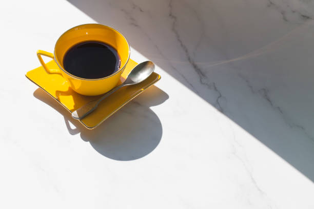istock yellow cup of coffee with sunshine isolated on white. 1283048442