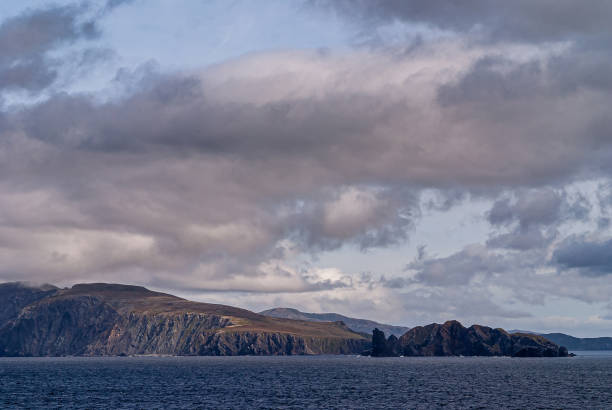 istock Rocks at edge of island under cloudscape, Cape Horn, Chile. 1283048564