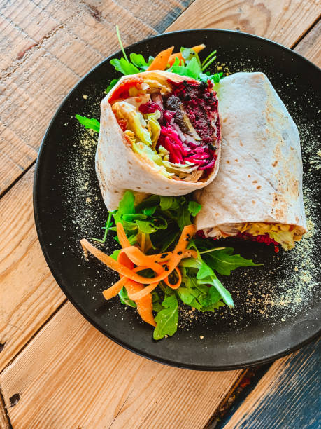 Vegan Burrito with Black Beans, Common Beet, Rice and Arugula Vegan Burrito with Black Beans, Common Beet, Rice and Arugula vegetarianism stock pictures, royalty-free photos & images