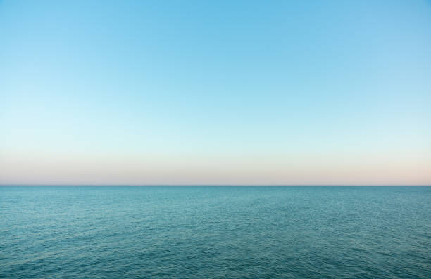istock Calm evening sea surface with clear blue sky. Evening seascape. 1283049032