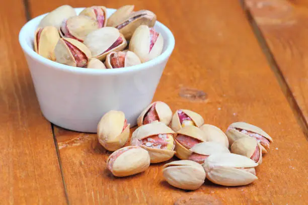 Photo of Pistachio  popular, healthy, on a rustic background of wood, close-up.