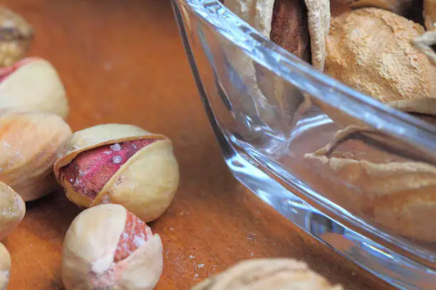 Photo of Pistachio  popular, healthy, on a rustic background of wood, close-up.