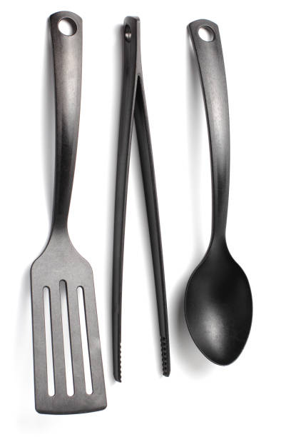 istock Close-up spoon, spatula and cook tweezers on a white background. 1283049781