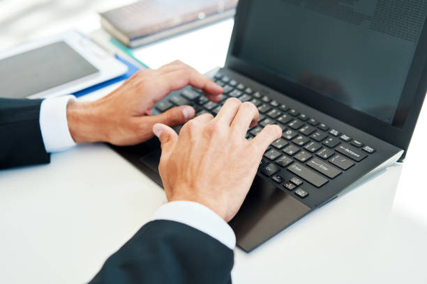 istock Closeup man's hands typing on a laptop 1283051154