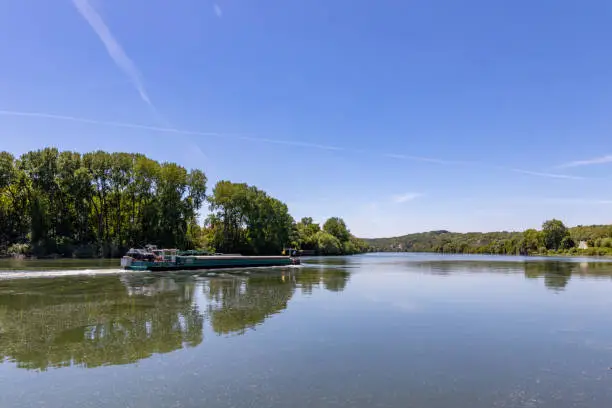 Photo of Barge moving on Seine River near La Roche-Guyon, Val d'Oise, France