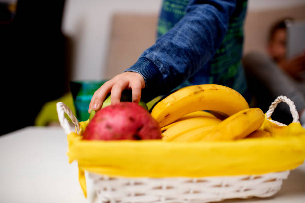 istock Close up of  boy taking apple from a healthy fruit basket 1283054948