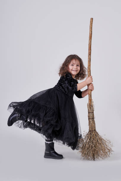 istock funny witch girl on a white background with a broom 1283054981