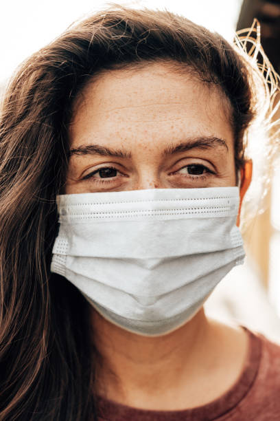 istock woman with face mask outdoors 1283056883