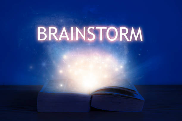 istock Open book with brainstorm inscription. Light coming from open book with word brainstorm. 1283058237