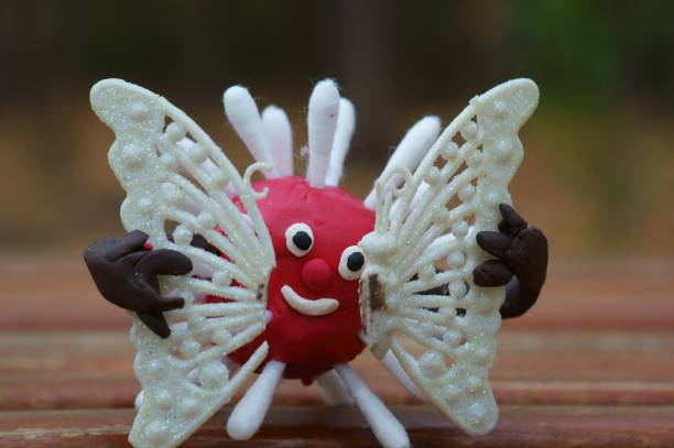istock A plasticine virus figurine holds a broken butterfly in its hands. 1283060296