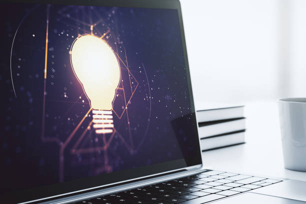 istock Creative light bulb hologram on modern laptop monitor, idea concept. 3D Rendering 1283060999
