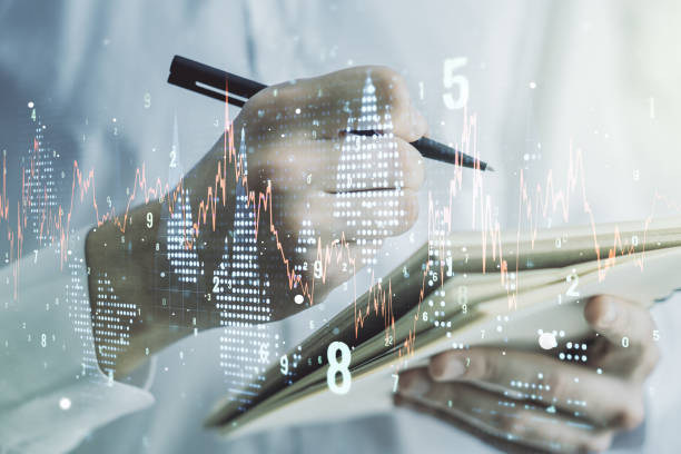 istock Multi exposure of abstract financial graph with hand writing in notebook on background, financial and trading concept 1283061662