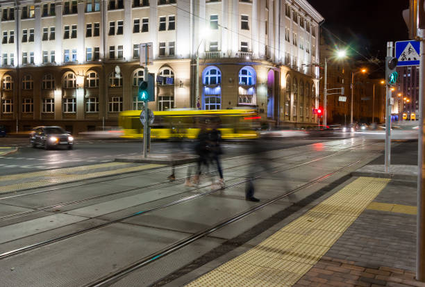 istock Passers-by cross the tram rails in the evening 1283063947
