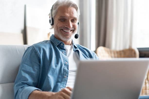 istock Smiling male call center agent or telemarketer work consult client online, good customer service concept 1283064163
