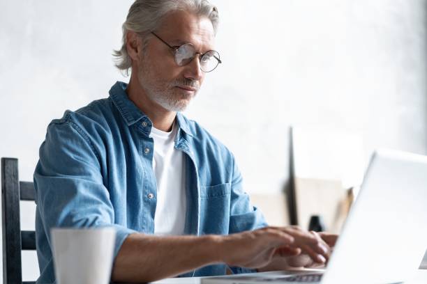 istock Middle-aged man working from home-office on laptop. 1283065766