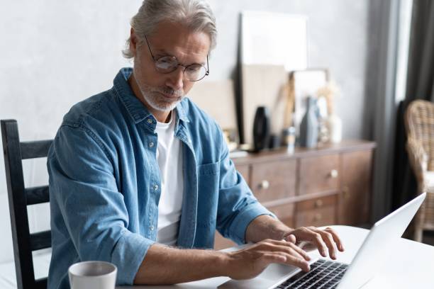 istock Middle-aged man working from home-office on laptop. 1283065771