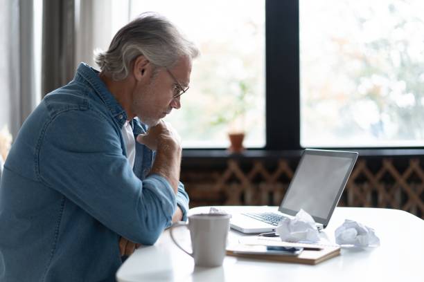 istock Stressed tired freelancer having headache and thinking how to finish his work, sitting and suffering at his home office 1283065784