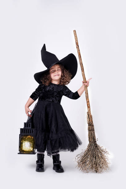 istock funny witch girl on white background with broom 1283065902