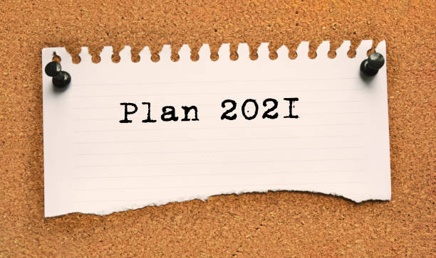 istock Paper note written with PLAN 2021 inscription on cork board 1283066753