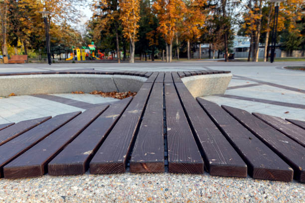 istock Original benches in a beautiful colorful autumn park on a sunny day. Selective focus. 1283068065