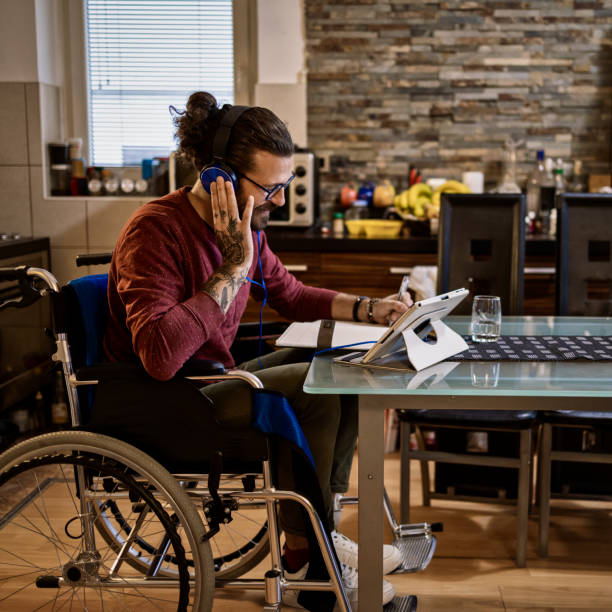 istock Man in wheelchair at home 1283071589