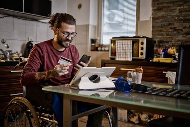 istock Man in wheelchair at home 1283071591